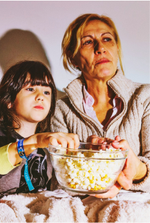 Grandma and granddaughter watching TV
